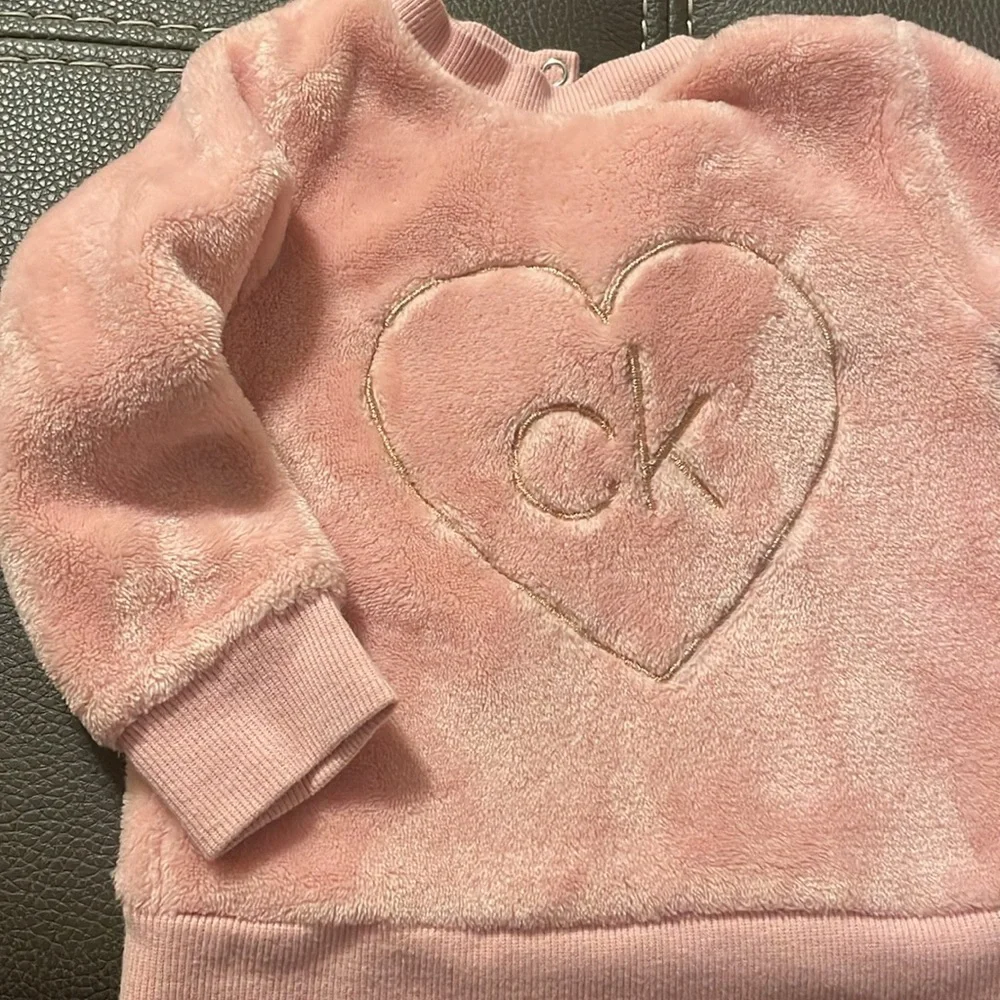 Calvin Klein size 12 months. Soft pink‎ two snap buttons behind neck. GUC.